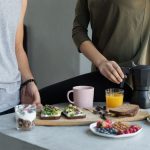 Cozy morning breakfast with avocado toast, coffee, and fresh juice.