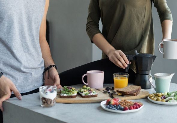 Cozy morning breakfast with avocado toast, coffee, and fresh juice.